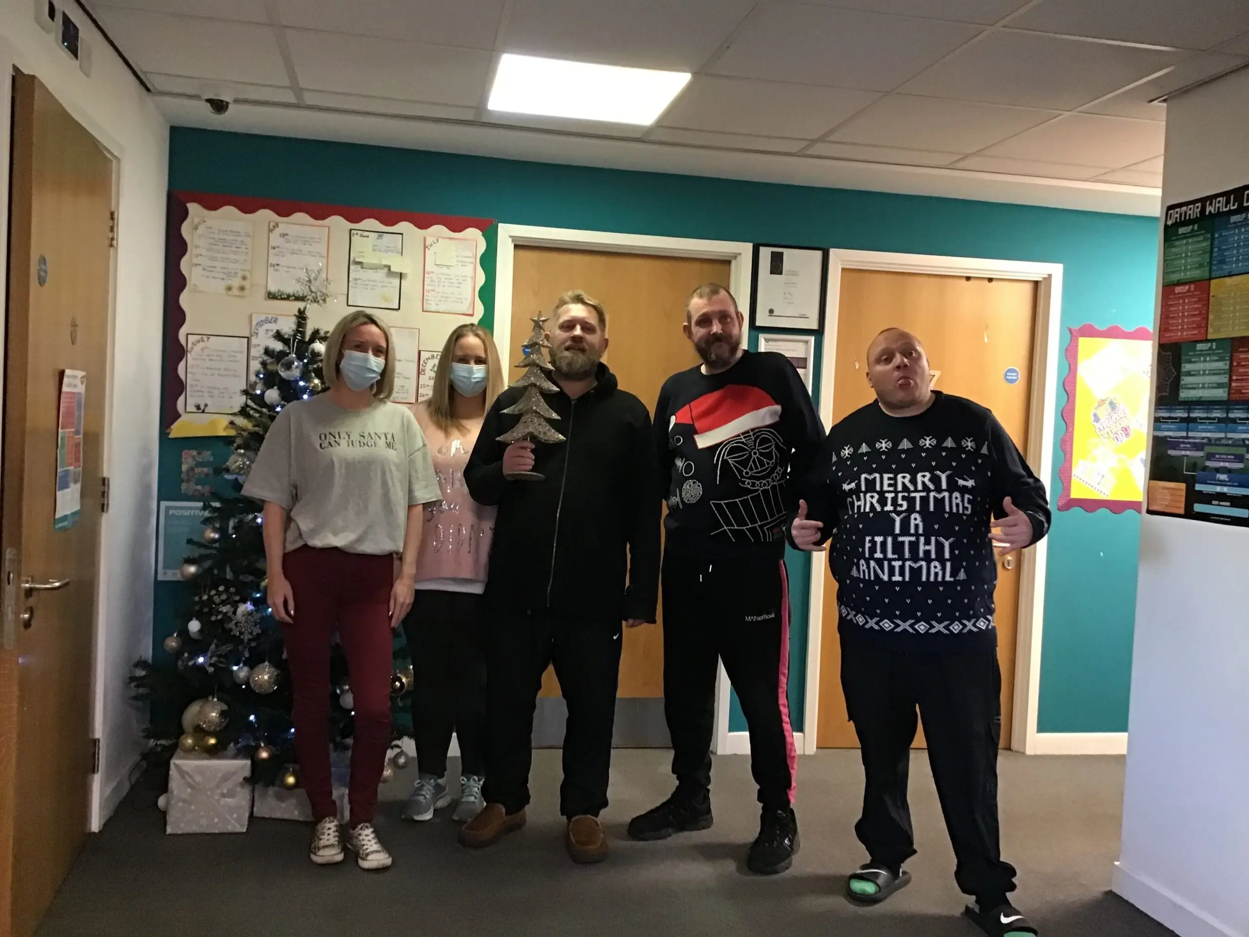 team members and residents wearing christmas jumpers