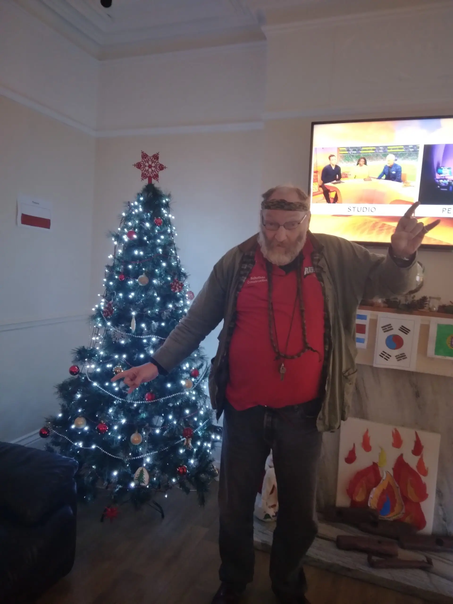 resident standing in front of Christmas tree